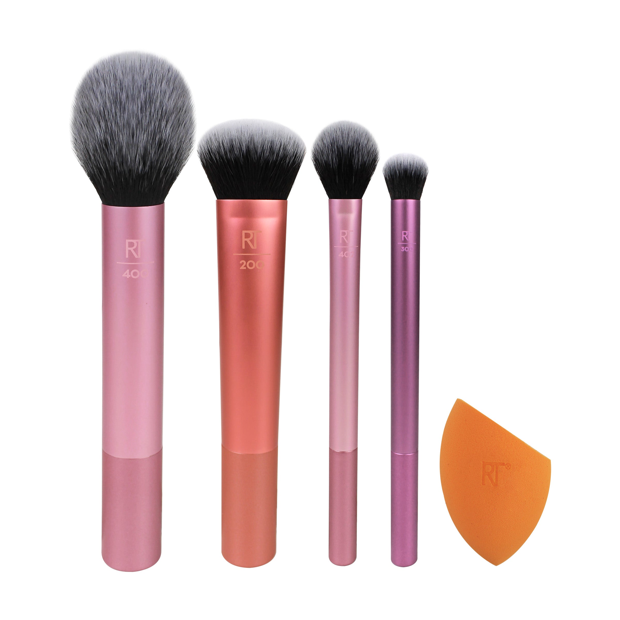 Four Real Techniques Everyday Essentials makeup brushes and an orange complexion sponge